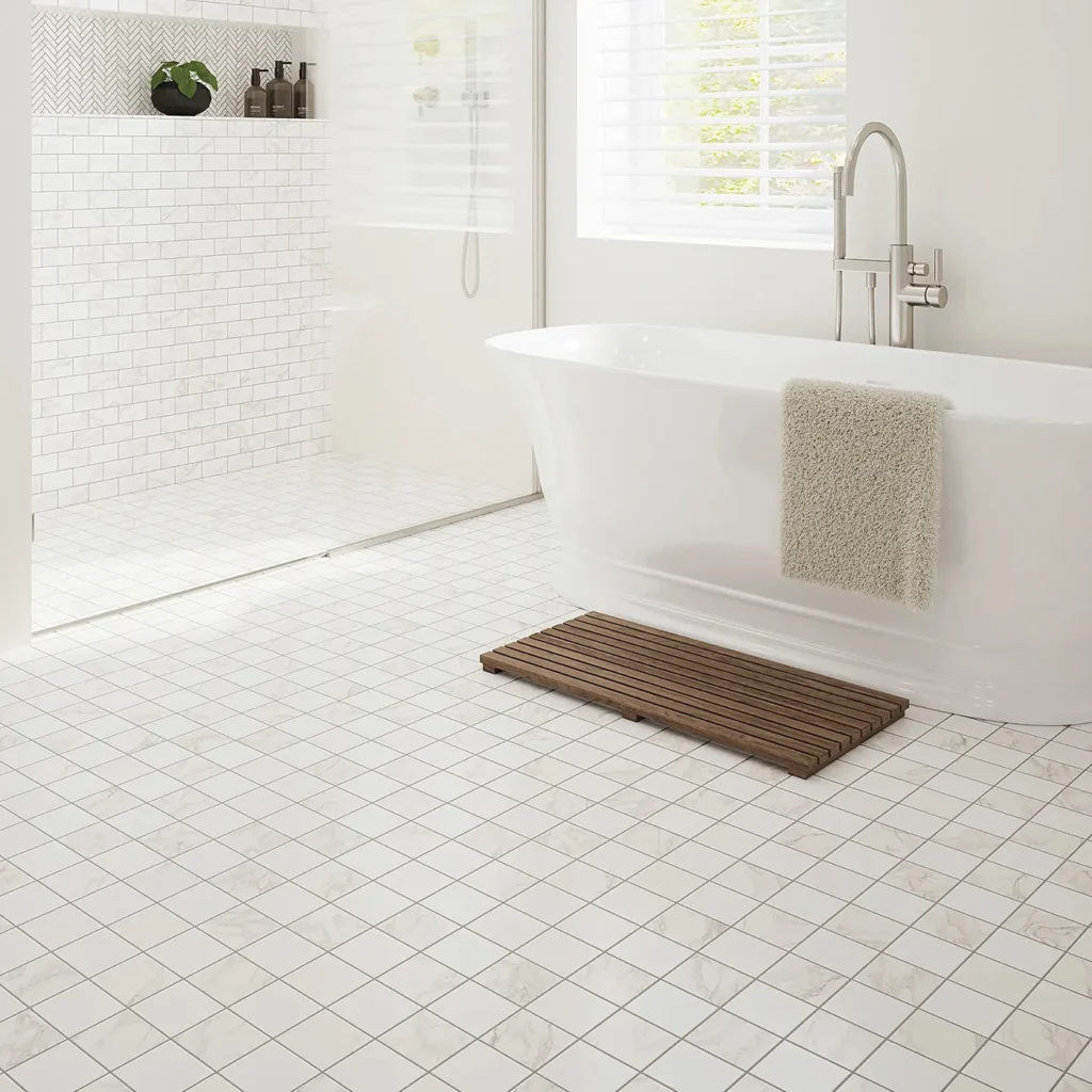 White bathroom with freestanding tub and teak bath mat on small white checkered Shaw Floors Eterna tile flooring