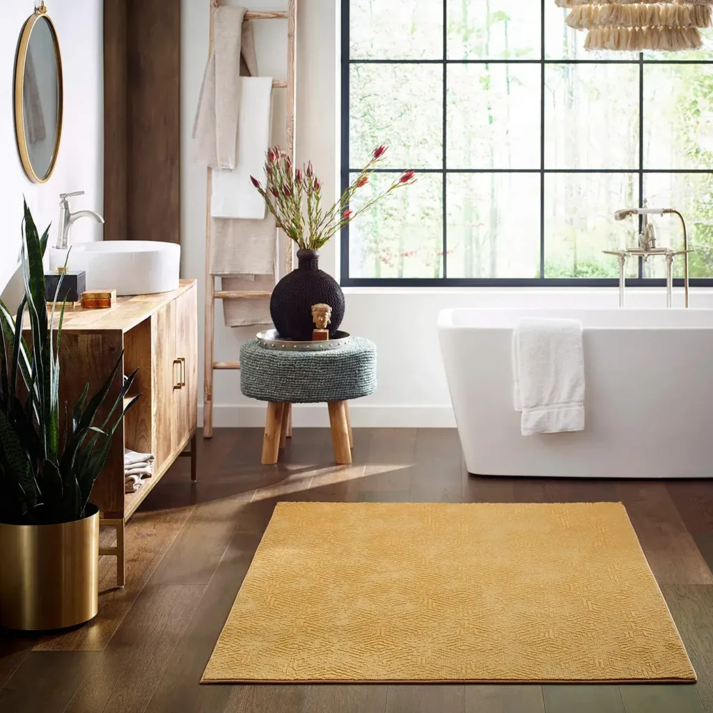 Boho bathroom with freestanding tub and a vibrant mustard yellow Shaw Floors Exquisite area rug on dark wood flooring
