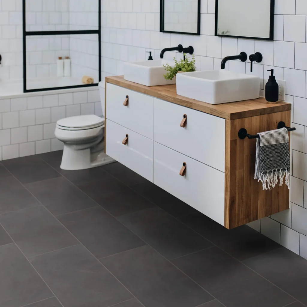Modern bathroom with floating wood vanity and white wall tile on dark gray Shaw Floors Callisto Ember rectangular floor tile