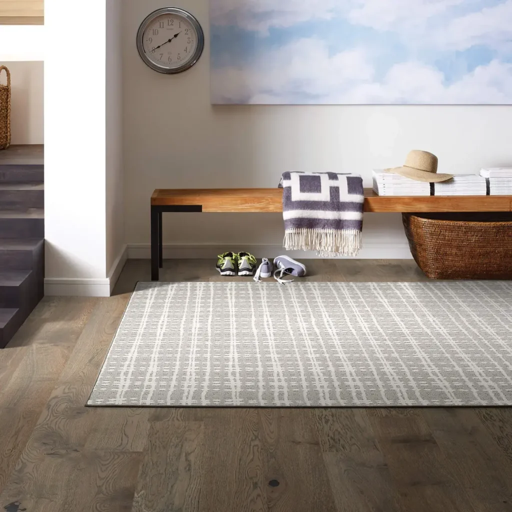 Entryway with wood bench on a light gray plaid Shaw Floors Armory Pure Envy area rug over wood flooring