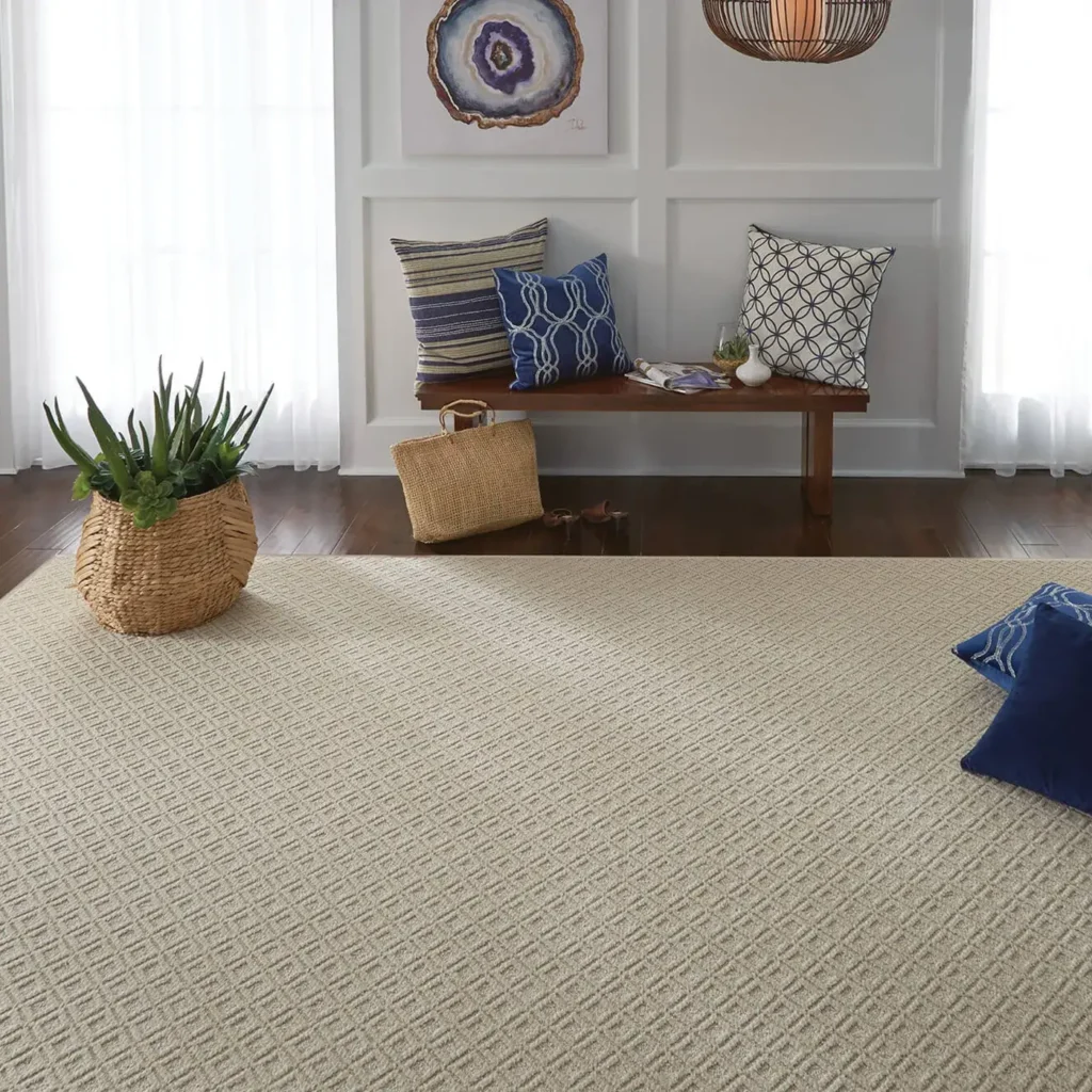 Bright sitting area with bench and throw pillows on a light sand-colored textured Shaw Floors Cutting Edge area rug