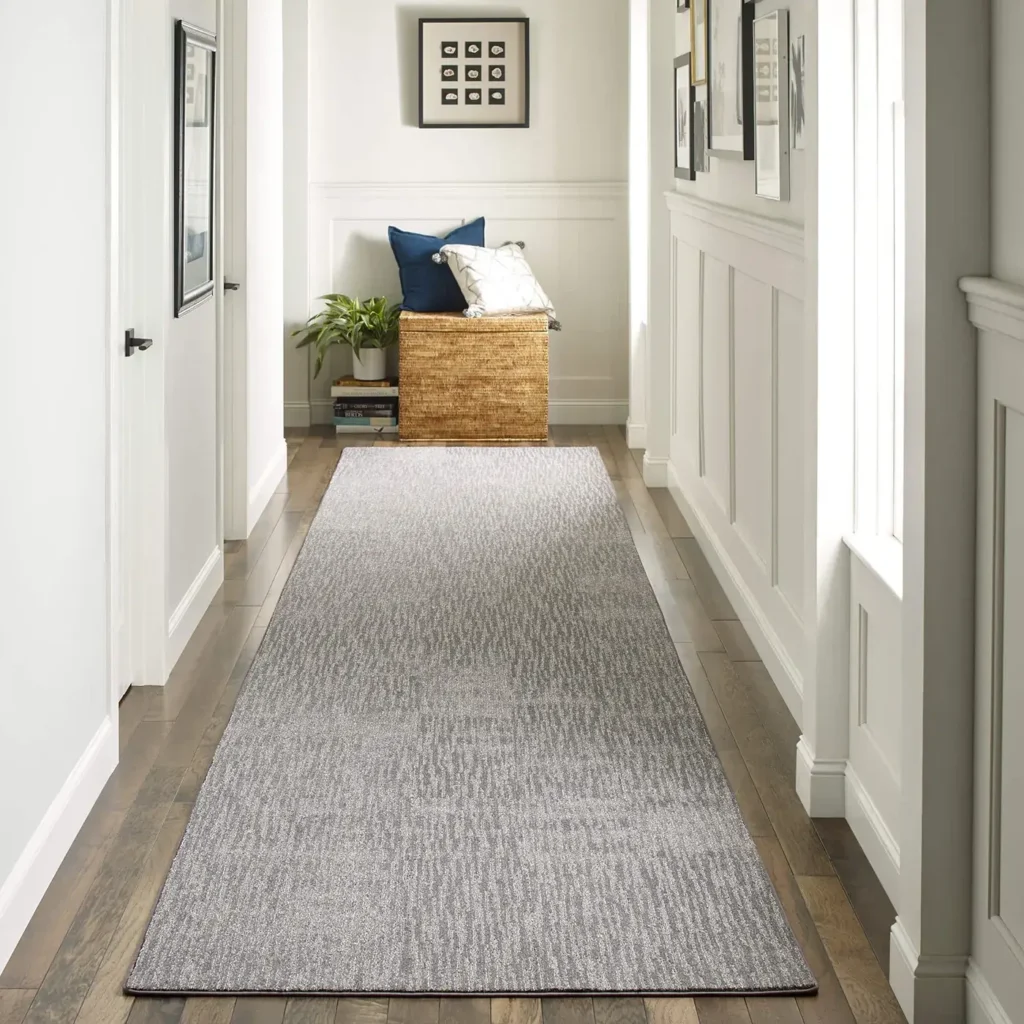 Long gray houndstooth Shaw Floors Dynamic Vision runner rug in a white hallway