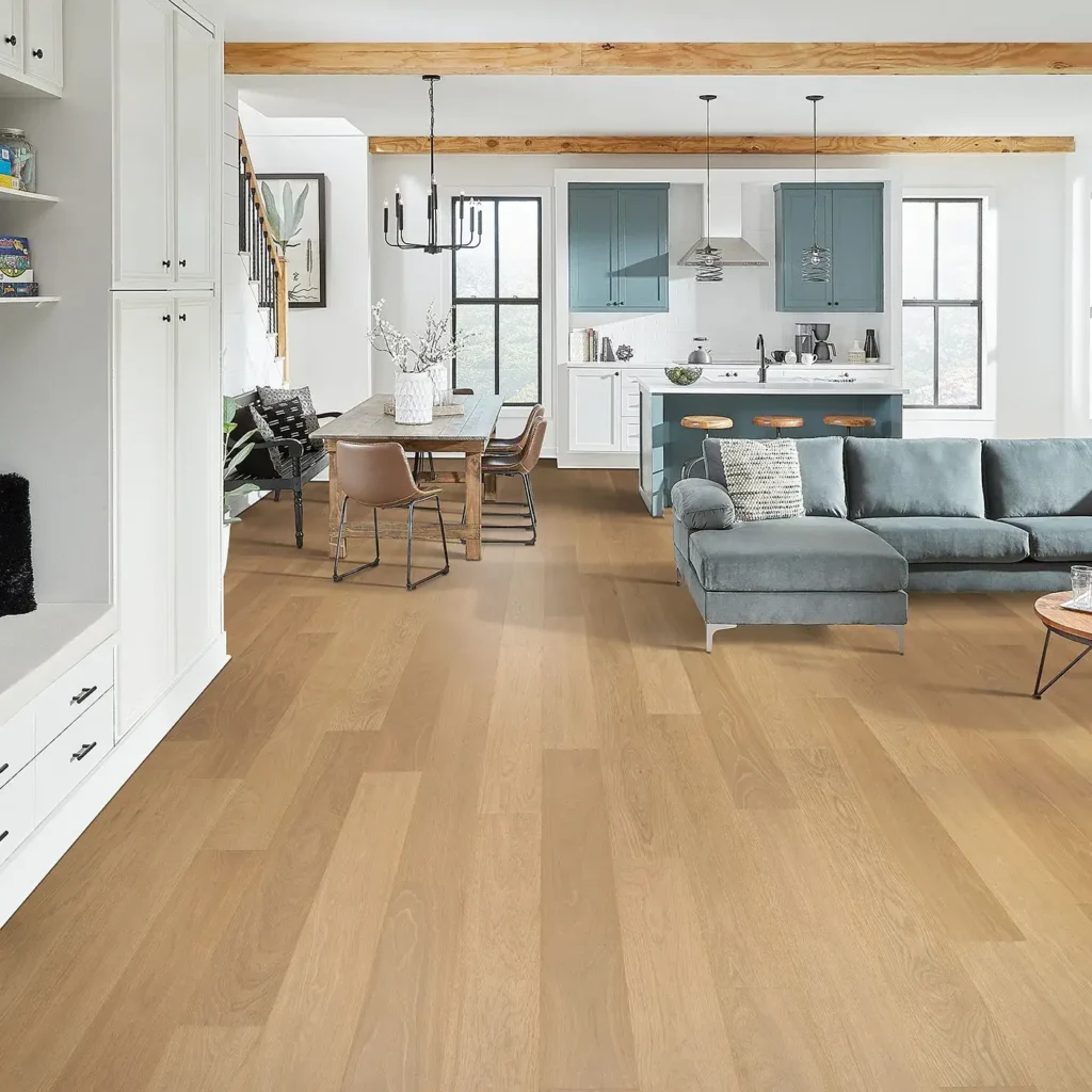 Open-concept living room and kitchen with light natural oak-look Mohawk RevWood Plus Adler Creek laminate flooring