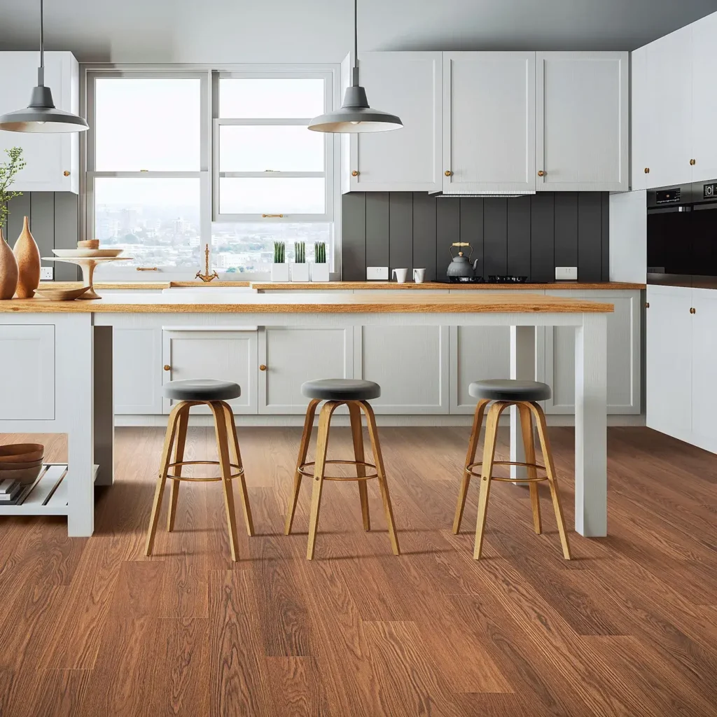 Kitchen with wood countertop island, three bar stools and warm reddish-brown Mohawk RevWood Plus Sterlington laminate flooring
