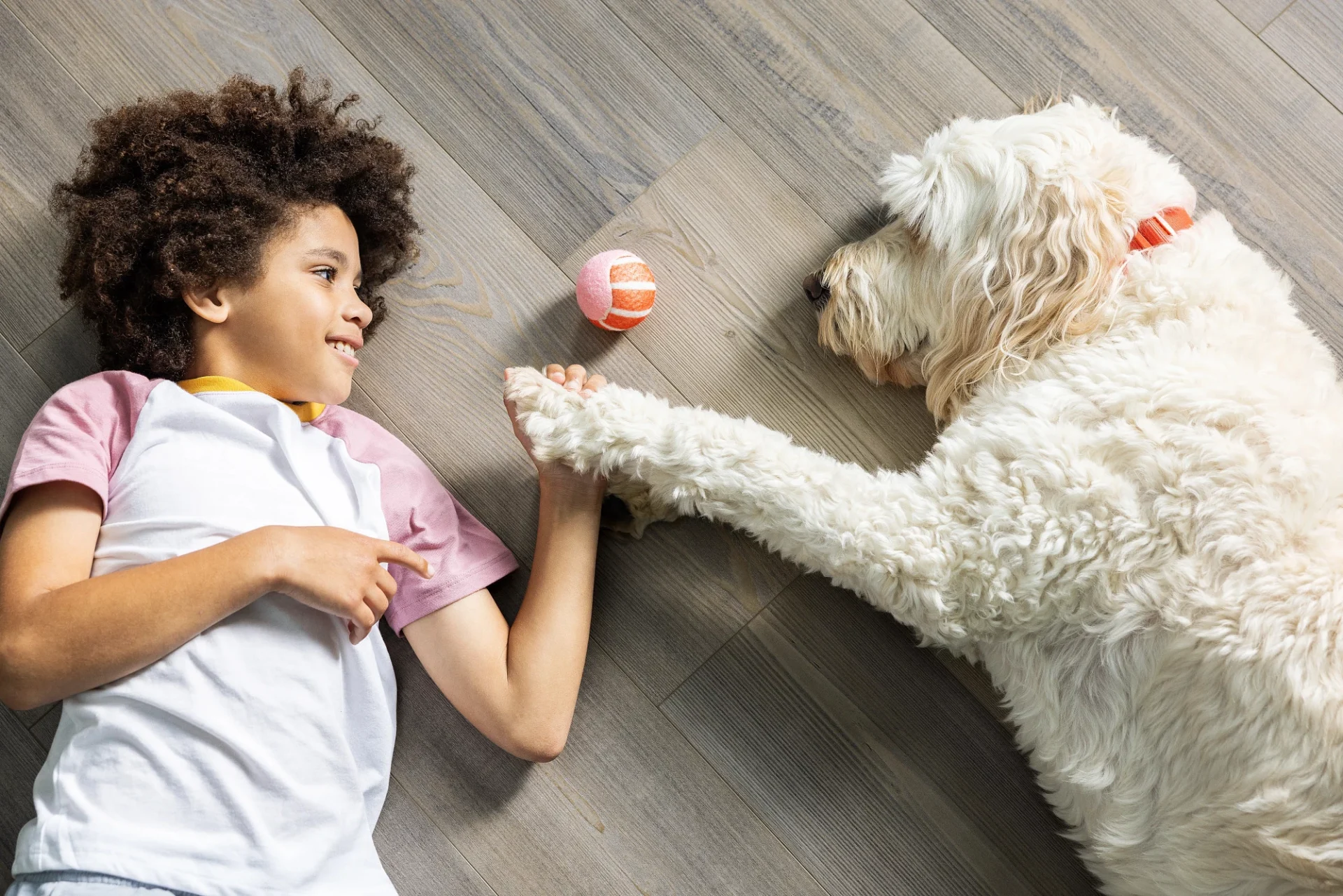 Child and dog playing on COREtec waterproof flooring