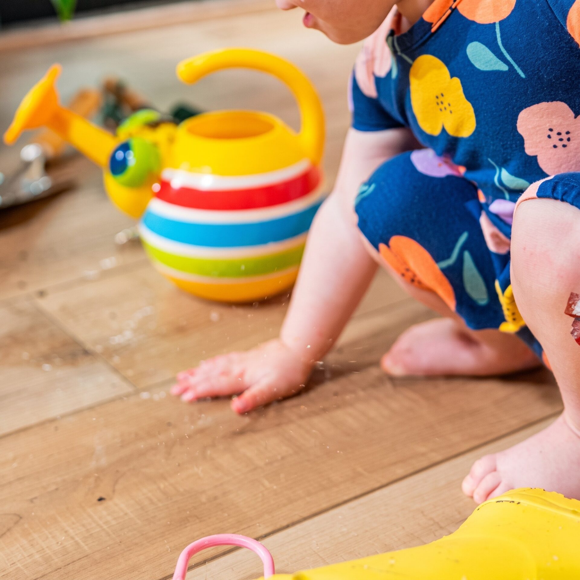 Toddler playing with toys on easy-to-clean COREtec flooring