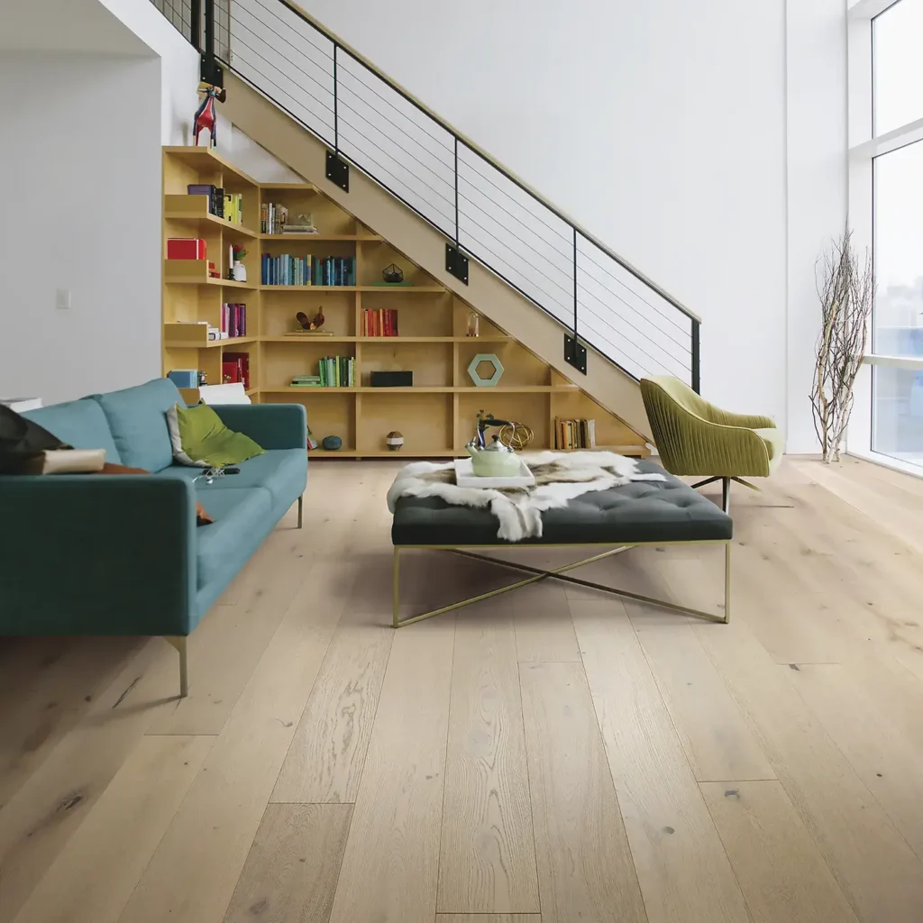 Light-colored Shaw Floors Expressions hardwood in a modern living room with a bookshelf staircase