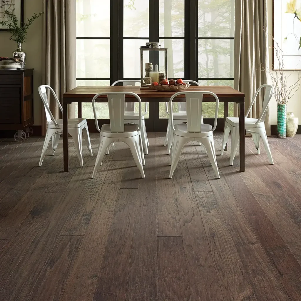 Gray-brown Shaw Floors Wayward Hickory hardwood in a dining room with a dark wood table