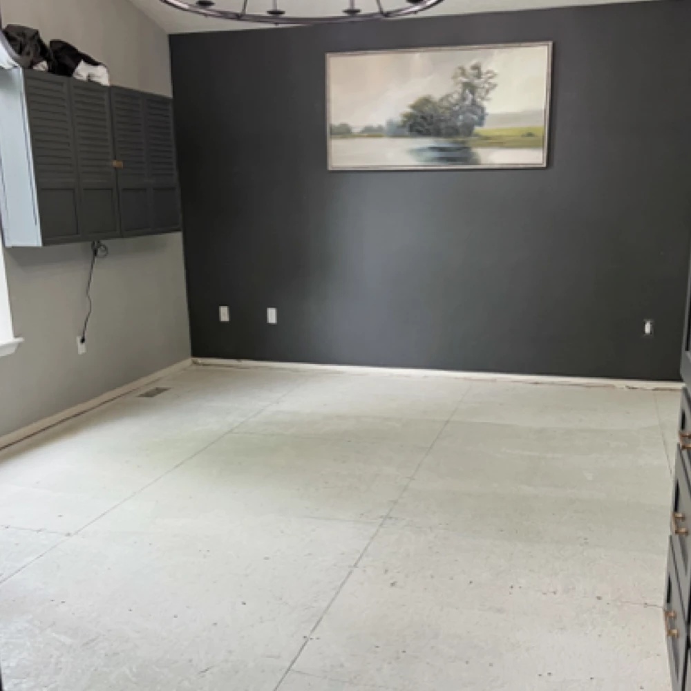 Worn flooring in a property management unit before renovation