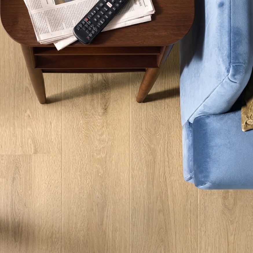 Light wood Shaw flooring with a side table and blue armchair