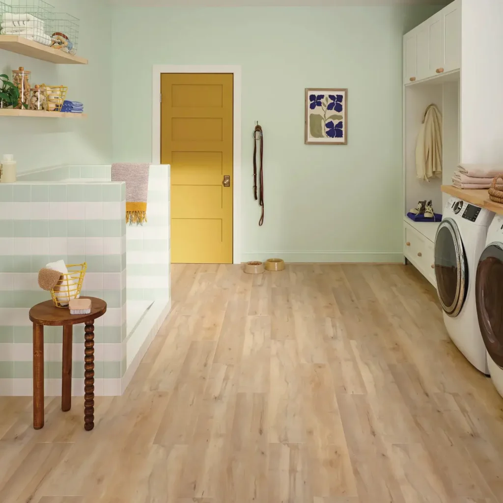 COREtec Brookfield Maple luxury vinyl in a light blonde wood color in a laundry room