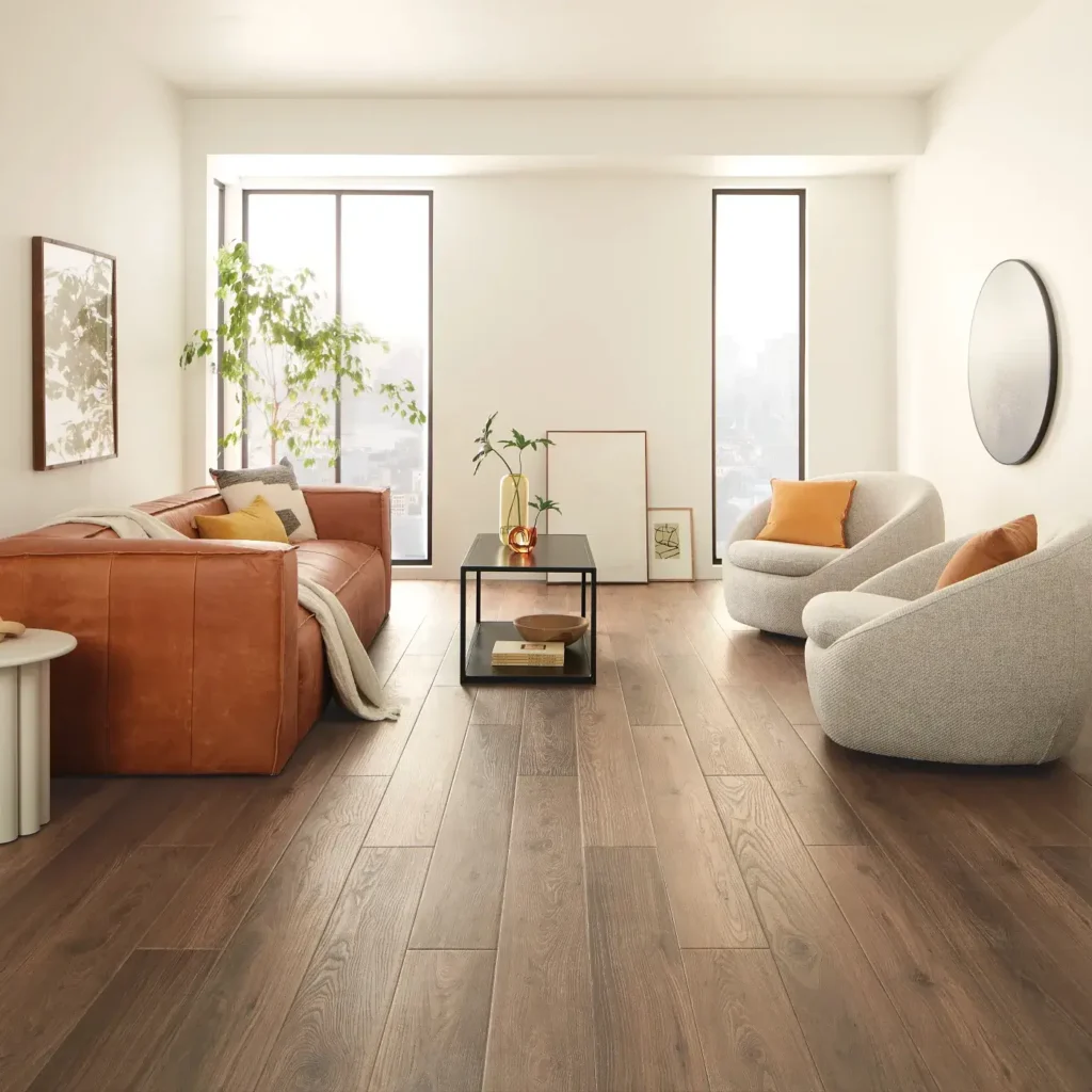 COREtec Tyro Walnut luxury vinyl in a dark brown wood tone in a bright living room